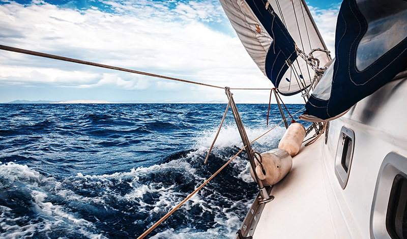 35811077 - the white sails of yachts on the background of sea and sky in the clouds